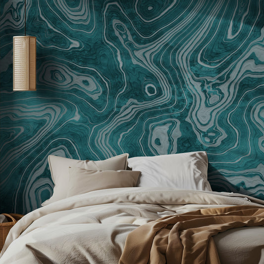 Bedroom with a bed against a wall featuring a green and white wood or marble pattern.