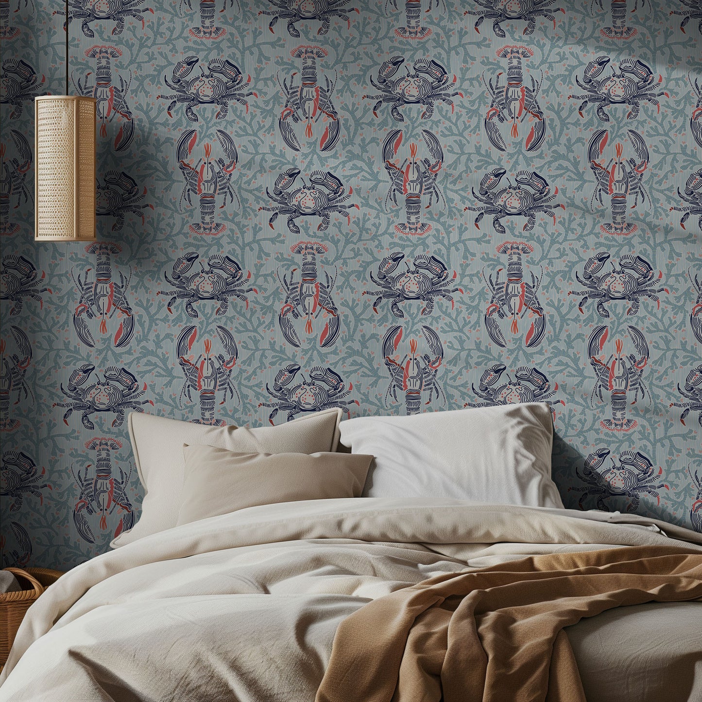 Bedroom with lobster and crab patterned wallpaper and beige bedding.