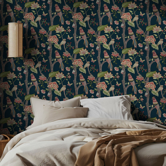 Bedroom with floral wallpaper featuring birds and flowers, beige bedding, and a lamp.