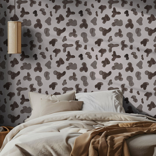 Bedroom with cow print patterned wallpaper and neutral bedding