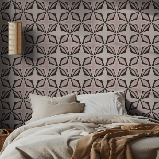 Bedroom with pink and muted green geometric patterned wallpaper and neutral bedding.