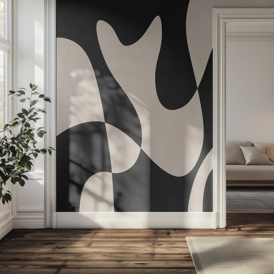Modern interior with abstract organic black and beige wall art mural, plant, and sofa.