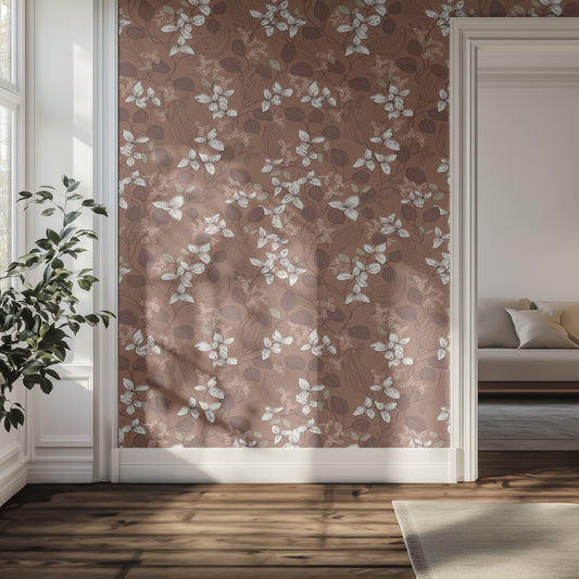 Hallway with white and brown floral-patterned wallpaper, plant, and sofa.