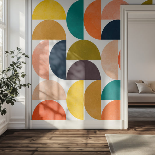 Colorful geometric wall mural in a hallway room with a plant and sofa.