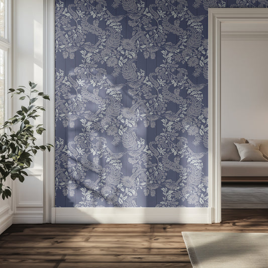 Hallway with blue floral and bird wallpaper on a wall, plant, and sofa.