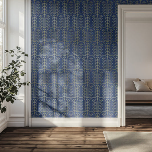 Room interior with a blue art deco patterned wall, plant, and sofa.