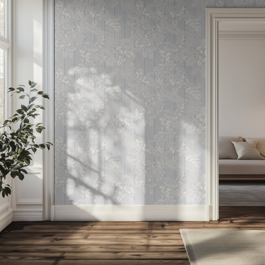 Hallway with light blue floral and white bird wallpaper on a wall, plant, and sofa in the background.