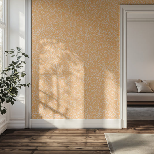 Living room with orange floral wallpaper, plant, and sofa