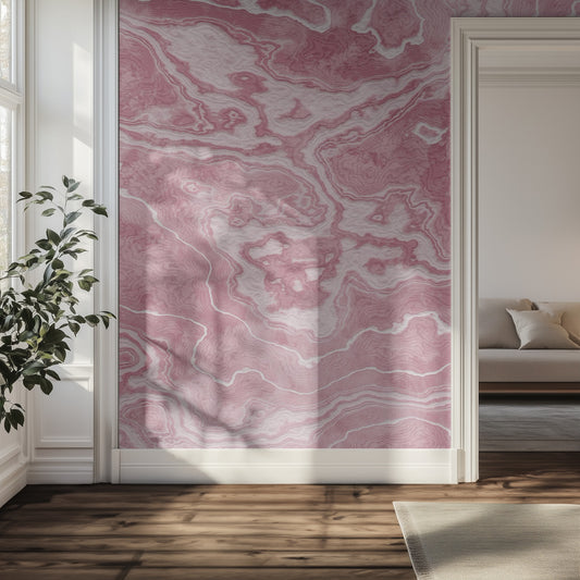 Room interior with pink marble-patterned wallpaper, plant, and sofa.