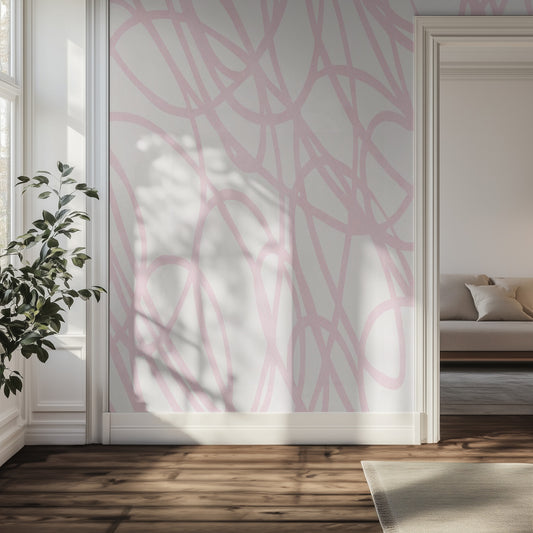 Living room with a pink line art wallpaper mural, wooden floor, and a plant.
