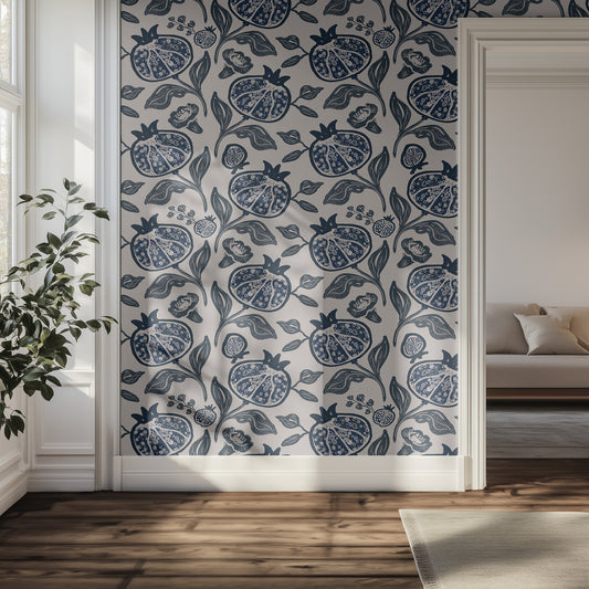 Hallway with blue pomegranate patterned wallpaper and a couch.