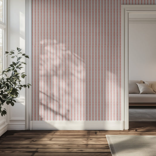 Living room with textured pink striped wallpaper, wooden floor, and a plant.
