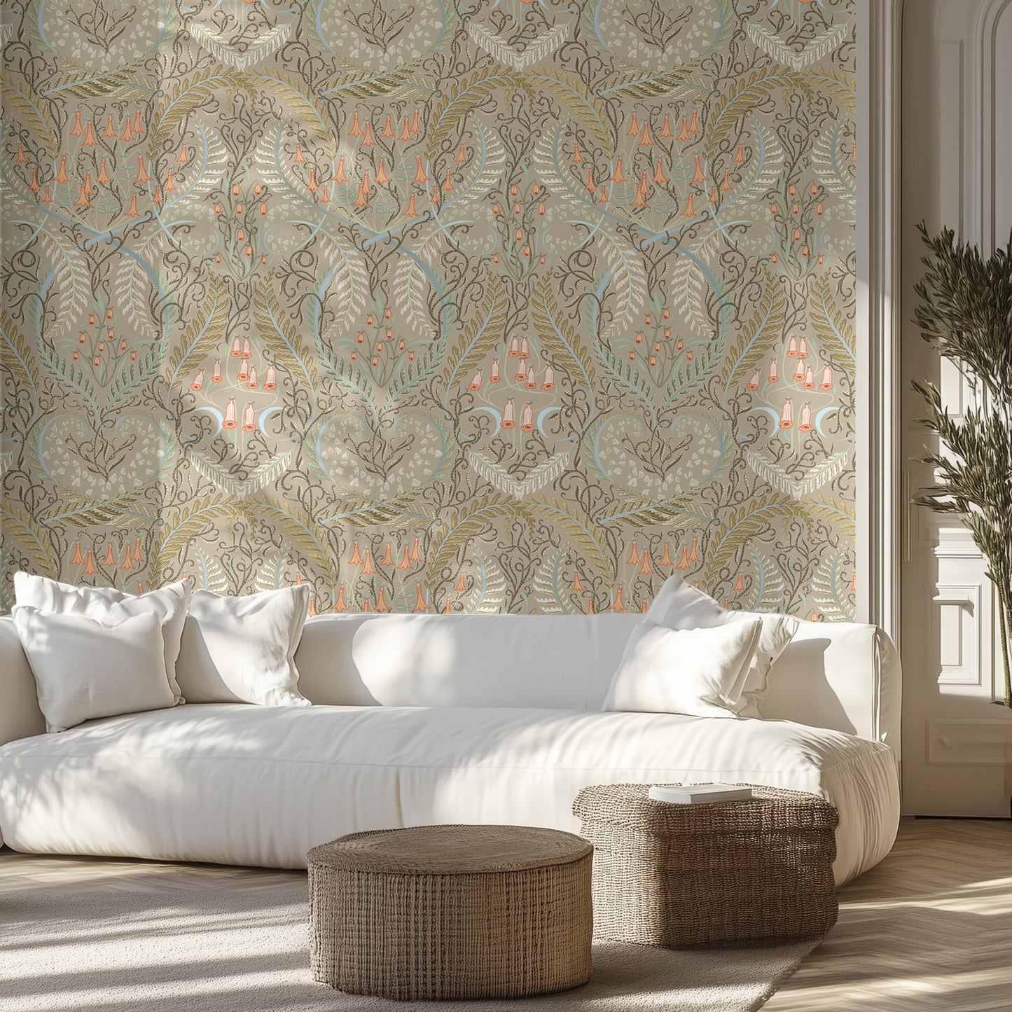 Living room with a white sofa, ornate taupe floral patterned wallpaper, and wicker ottomans.