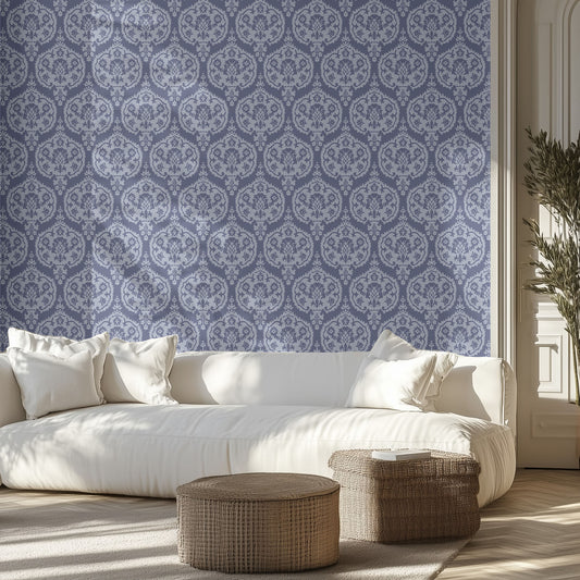 Living room with white sofa, two toned blue damask patterned wallpaper, and decorative ottomans.