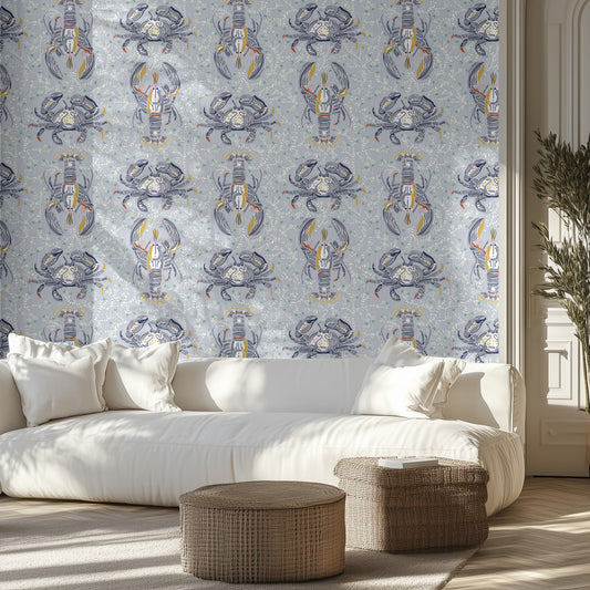 Living room with white sofa, light blue and dark blue stylized marine life patterned wall, and wicker ottomans.