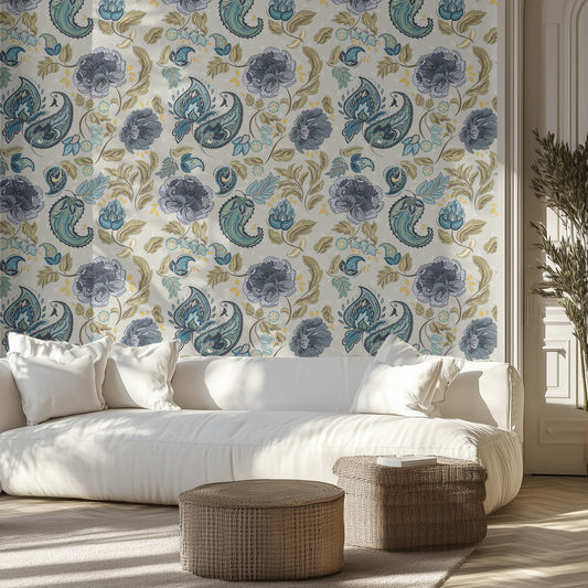 Living room with blue paisley and floral wallpaper, white sofa, and wicker ottomans.
