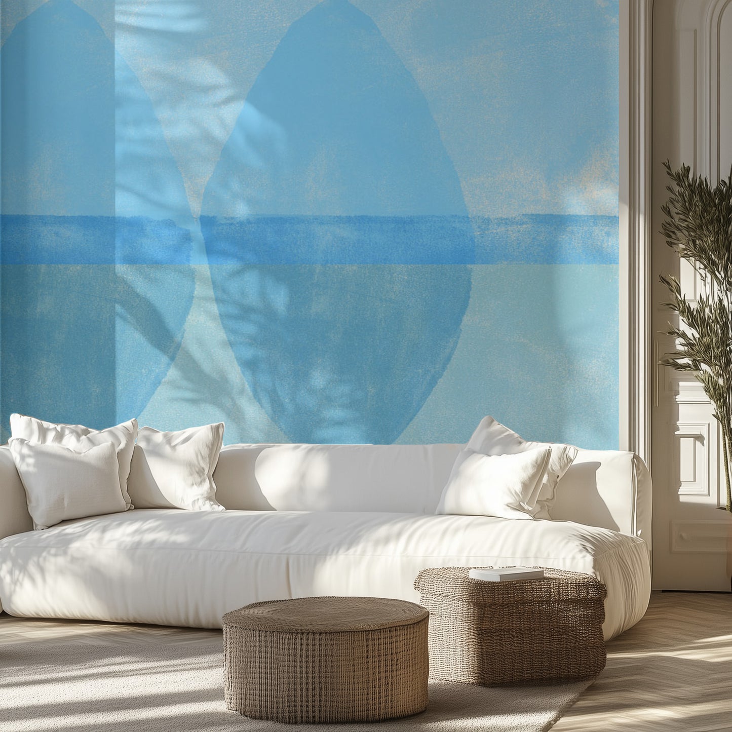 Modern living room with a white sofa, wicker ottomans, and abstract blue wall mural.
