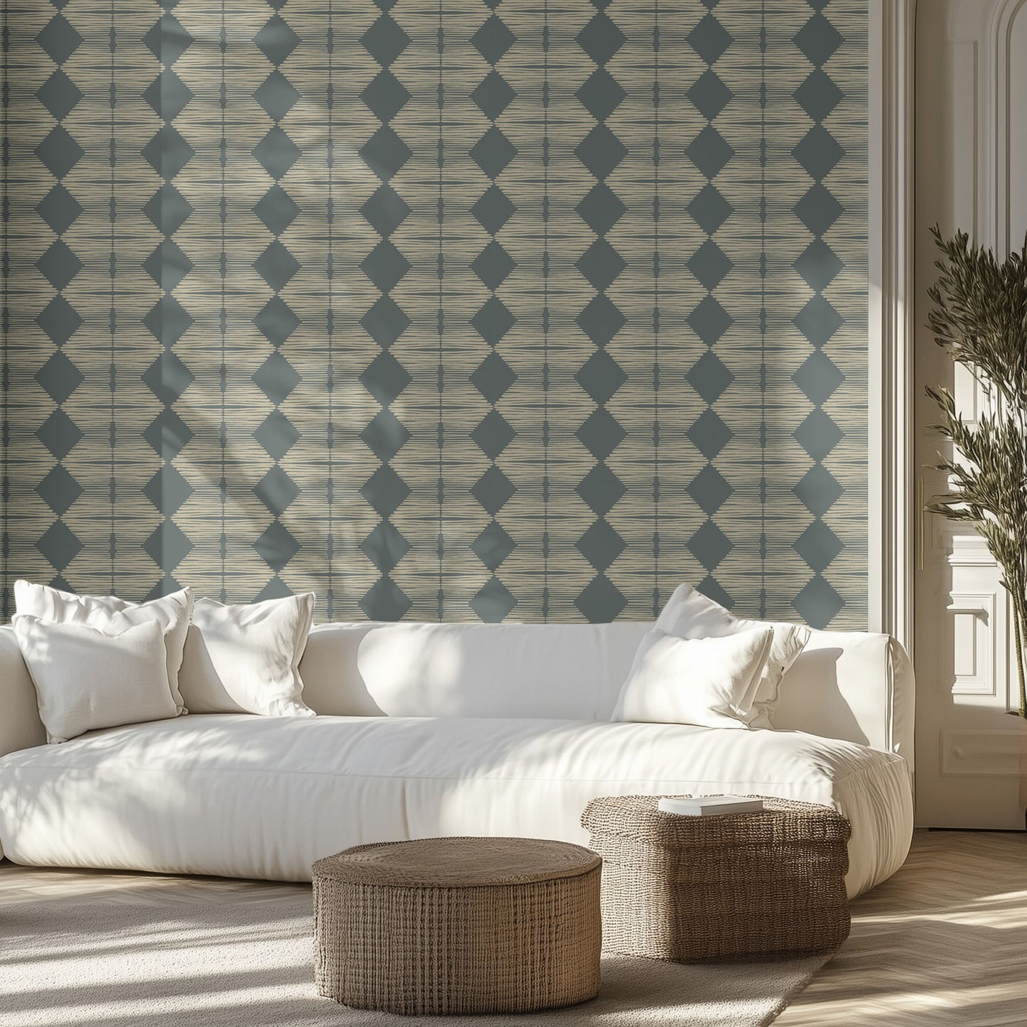Living room with a white sofa and a textured geometric diamond patterned wallpaper on the walls.