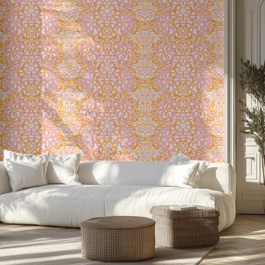 Living room with a white sofa, bright pink and orange floral patterned wall, and decorative ottomans. 