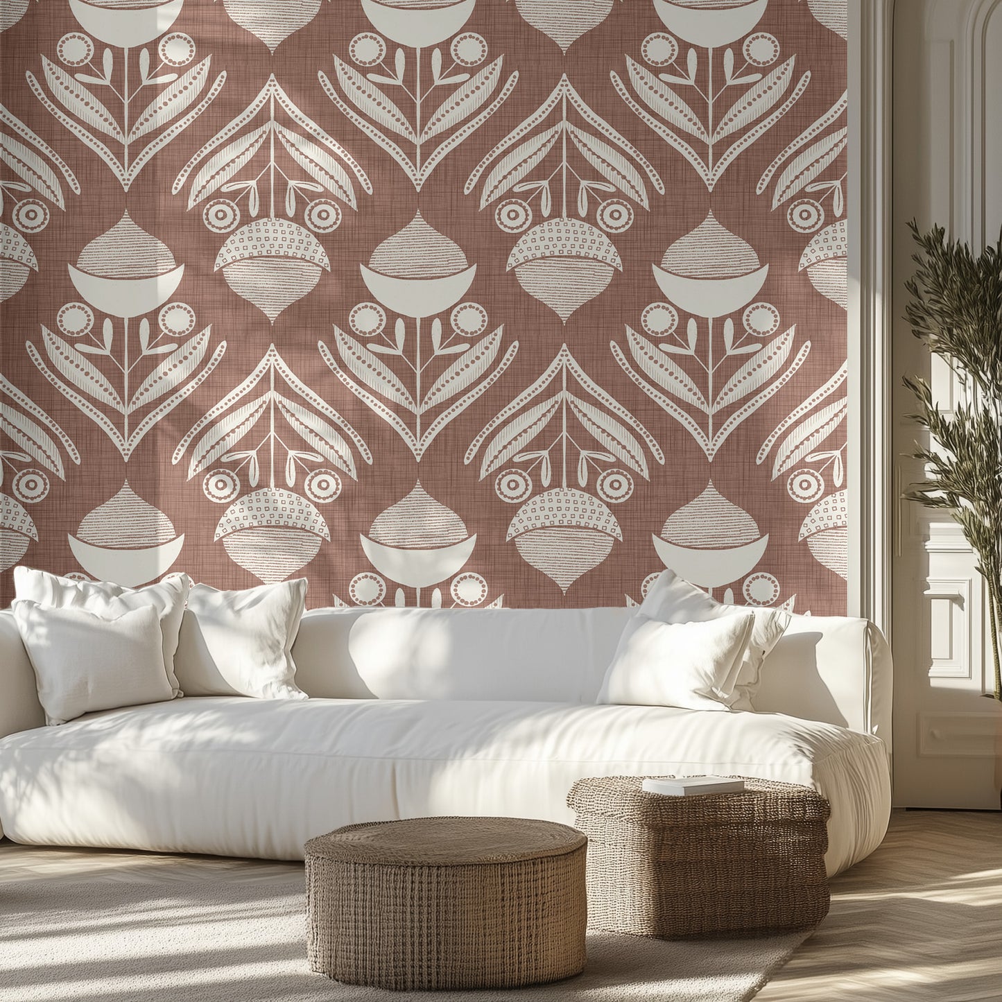 Living room with a brown and white textured wallpaper pattern of acorns and leaves, white sofa, and wicker ottomans.