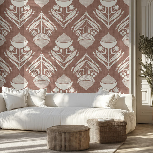 Living room with a brown and white textured wallpaper pattern of acorns and leaves, white sofa, and wicker ottomans.