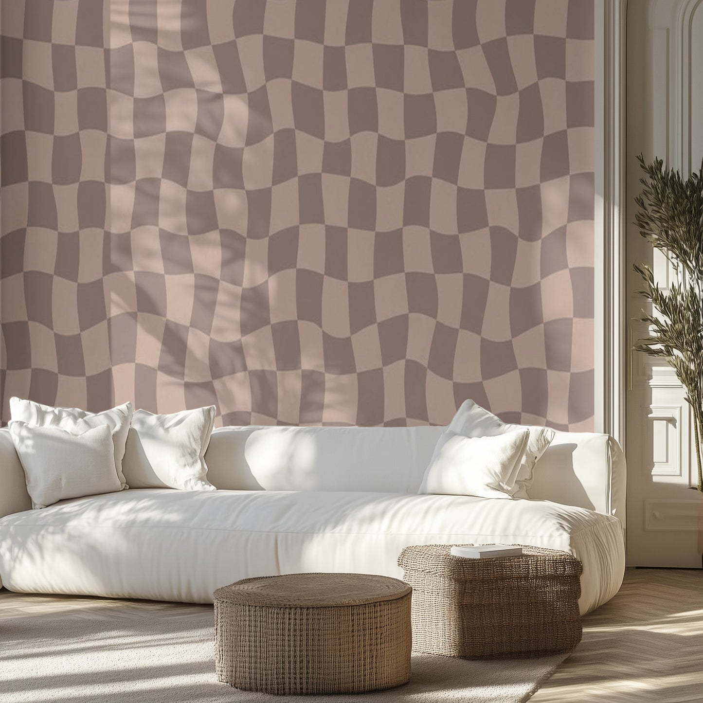 Living room with a white sofa, brown wavy checkered patterned wall mural, and wicker ottomans.