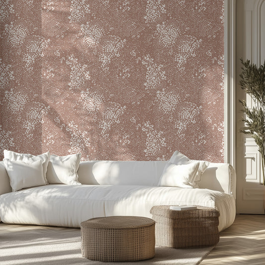 White sofa within a modern living room with neutral animal patterned wall in a bright room.