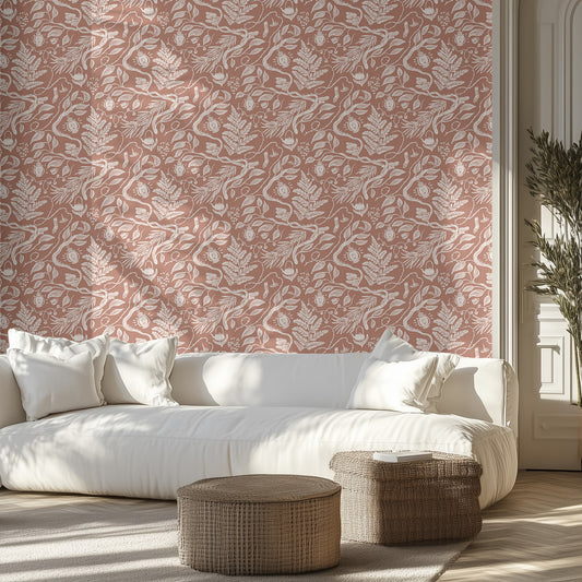 Living room with white sofa, brown and white boho foliage patterned wall, and wicker ottomans.