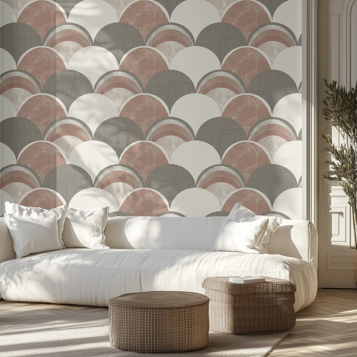 Living room with a tan and muted green, textured wallpaper patterned wall, white sofa, and wicker ottomans.