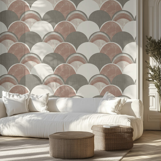 Living room with a tan and muted green, textured wallpaper patterned wall, white sofa, and wicker ottomans.