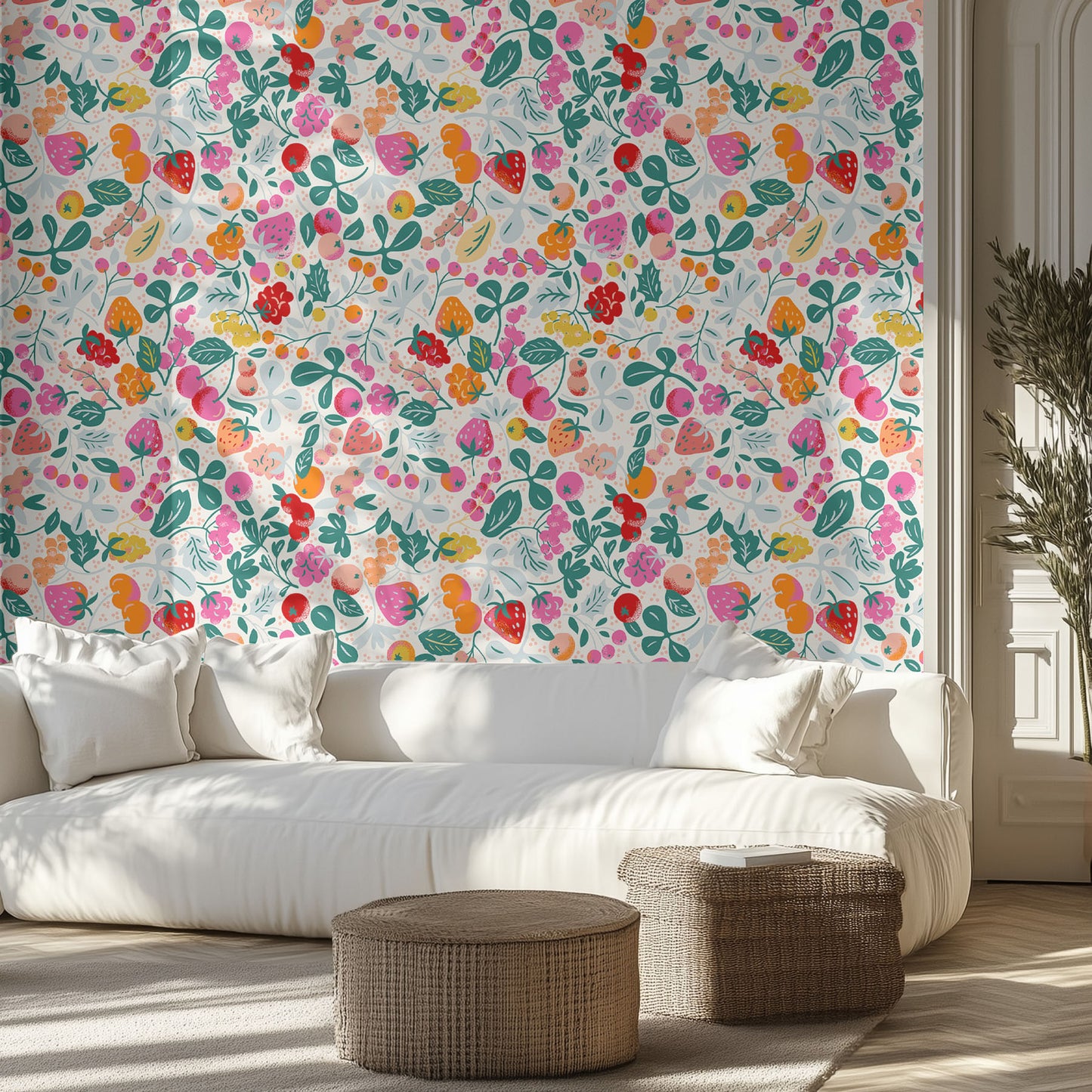 Living room with a vibrant wallpaper pattern of colorful berries and white sofa.