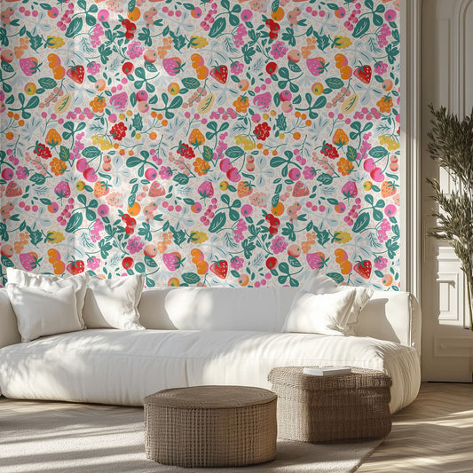 Living room with a vibrant wallpaper pattern of colorful berries and white sofa.
