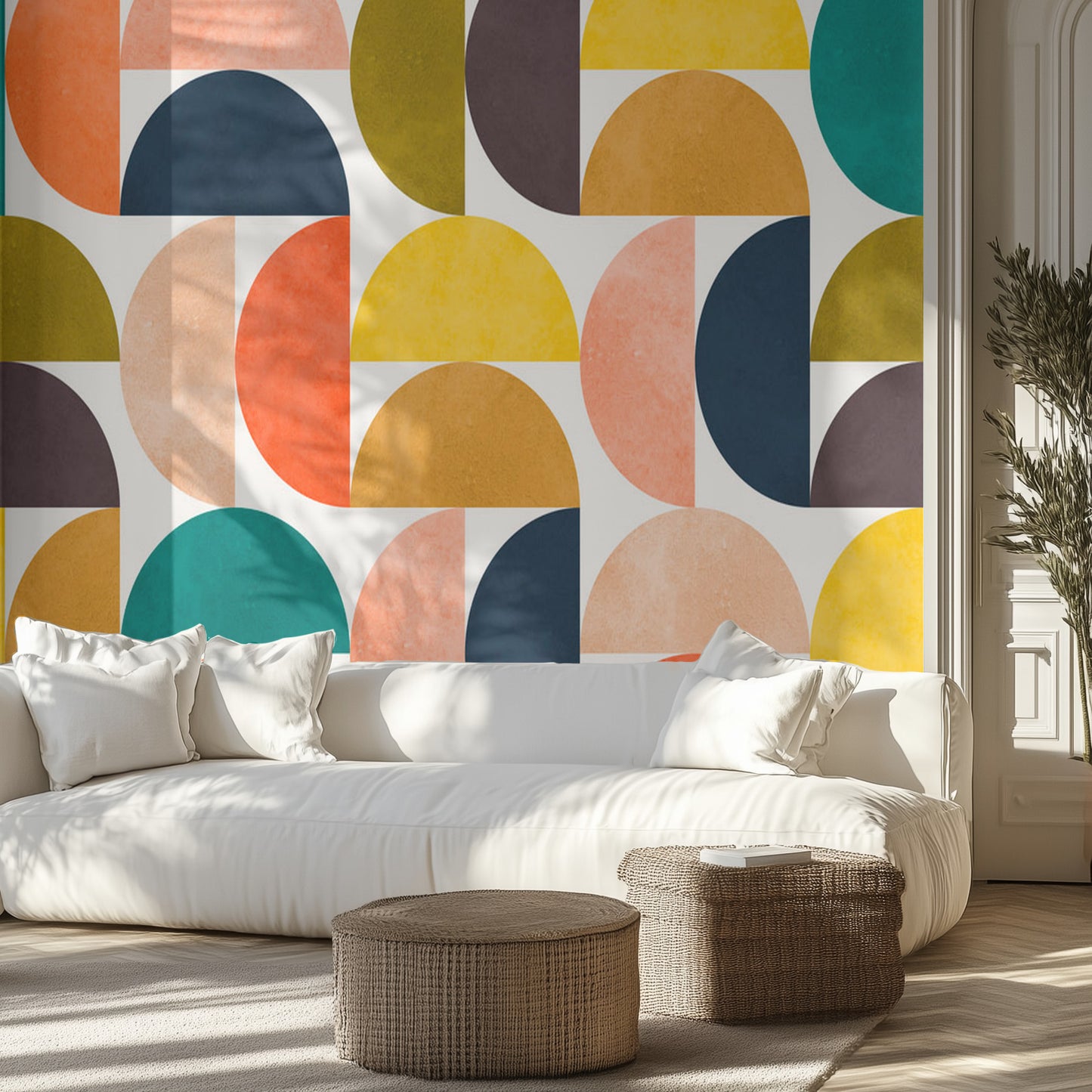 Modern living room with a colorful geometric wallpaper and white sofa.