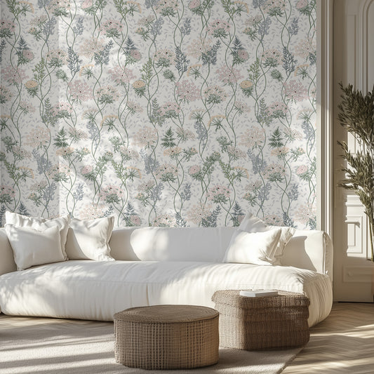 Living room with light floral wallpaper, white sofa, and wicker ottomans.