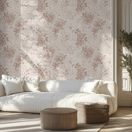 Living room with a white sofa, animal print patterned wall, and wicker ottomans.