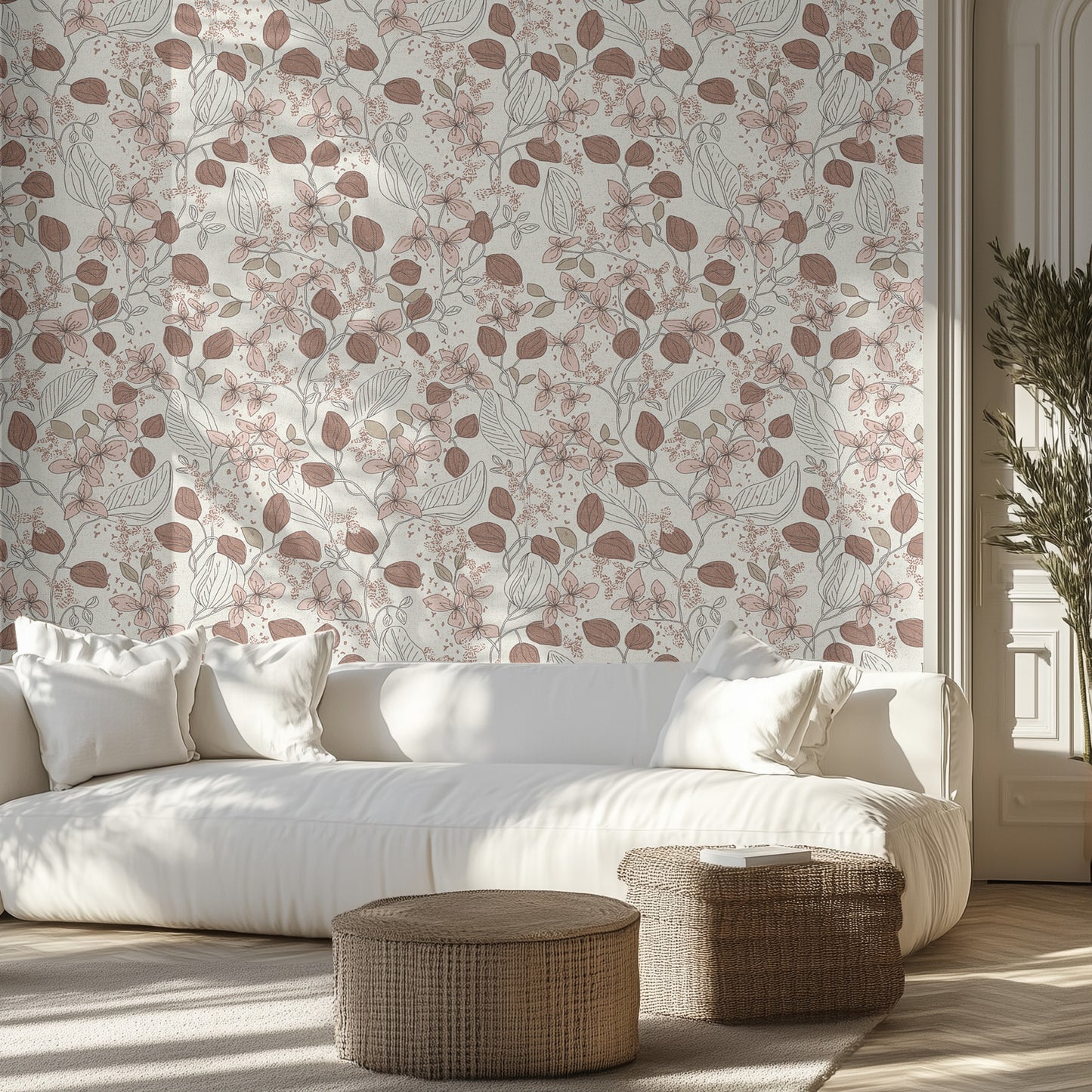 Living room with warm brown and cream floral wallpaper, white sofa, and wicker ottomans.