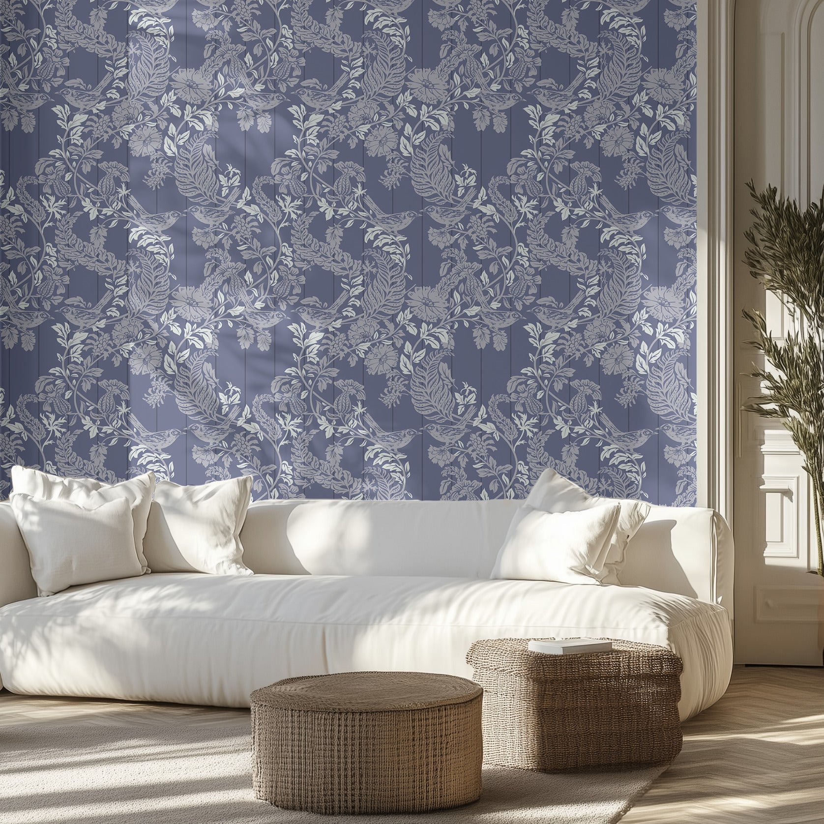 Living room with white sofa, decorative pillows, and patterned blue wall.