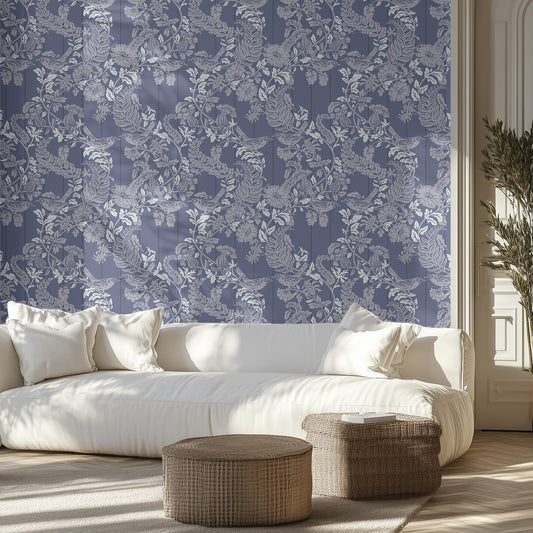 Living room with white sofa, decorative pillows, and patterned blue wall.