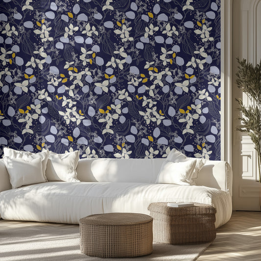 Living room with blue and white floral wallpaper, white sofa, and wicker ottomans.