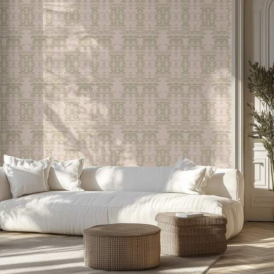 Modern living room with a white sofa, beige boho geometric patterned wall, and wicker ottomans.
