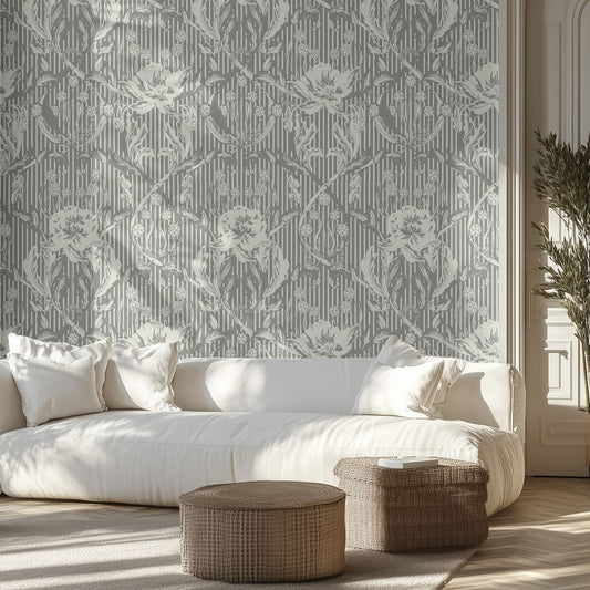 Living room with a white sofa, forest green and cream floral patterned wallpaper, and wicker ottomans.
