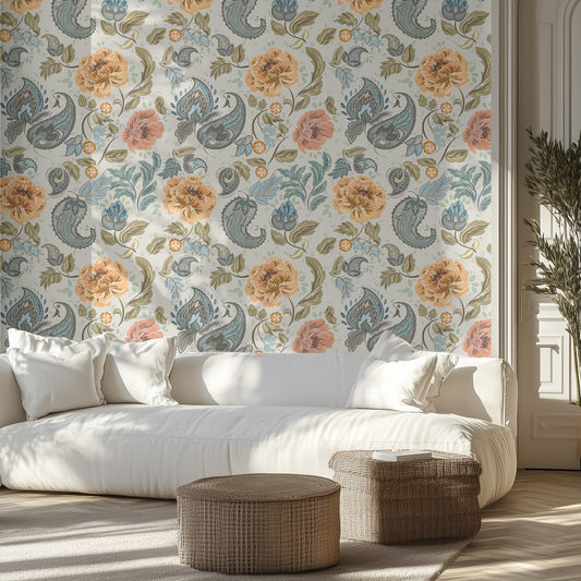 Living room with pale blue floral and paisley wallpaper, white sofa, and wicker ottomans.