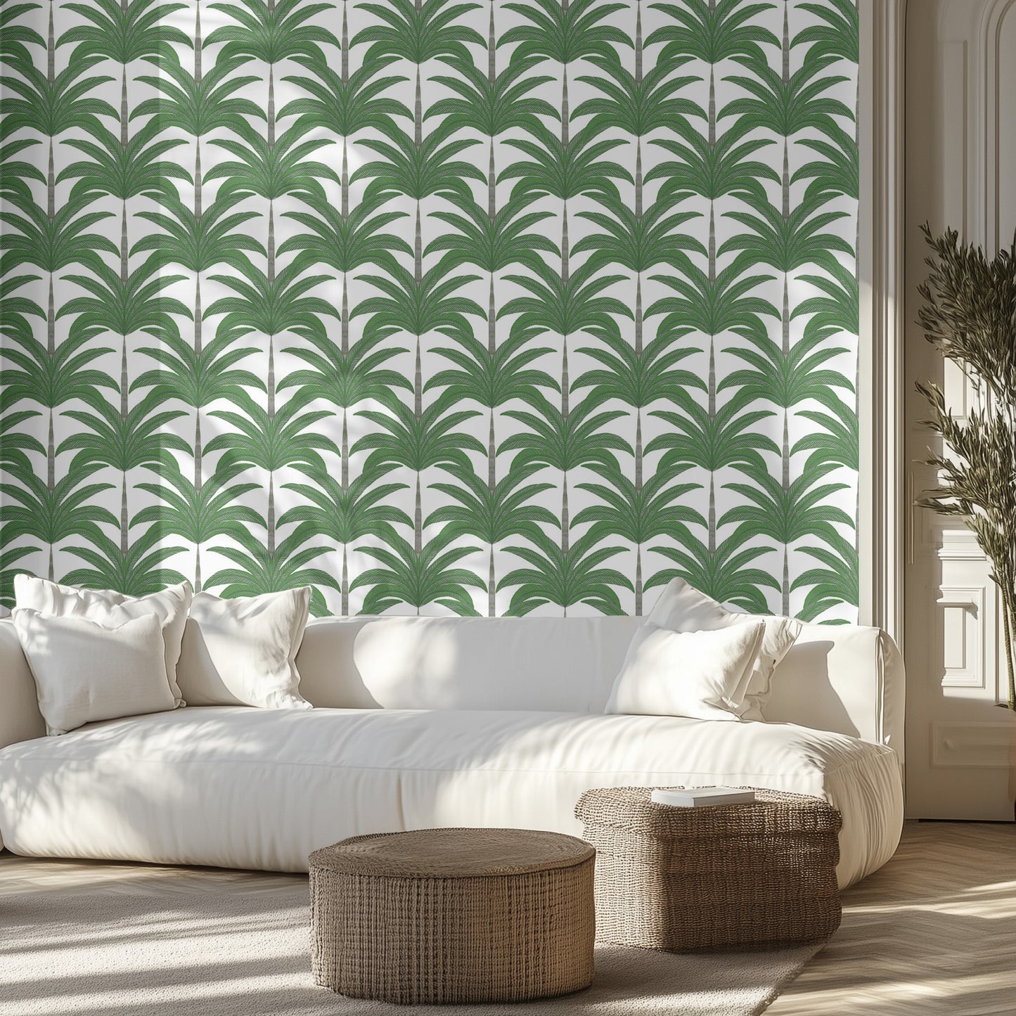 Living room with green palm wallpaper, white sofa, and wicker ottomans.