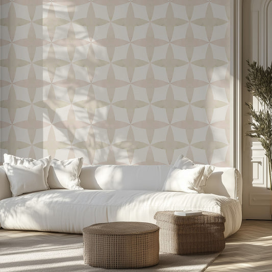 Modern living room with a white sofa, neutral geometric patterned wall, and wicker ottomans.