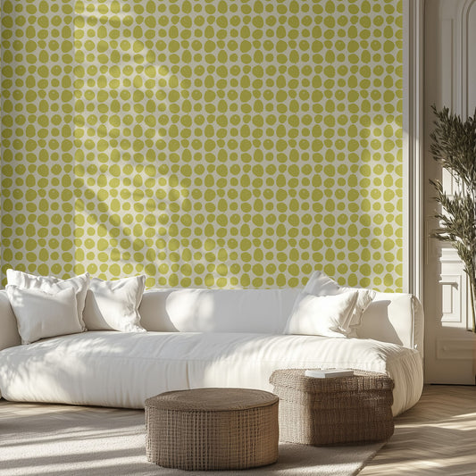 Living room with a white sofa against a lime green polka dot wallpapered wall.