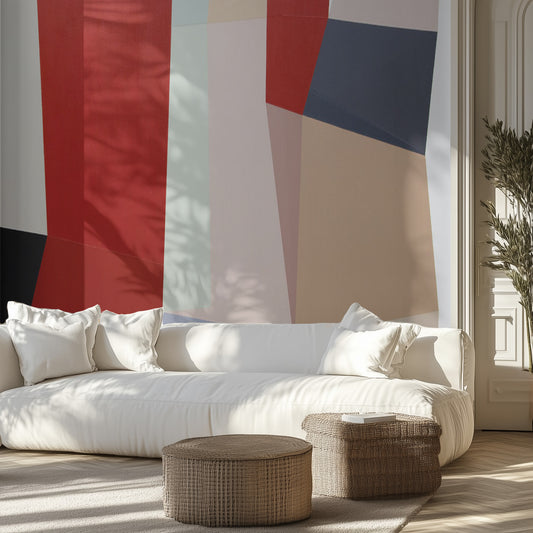 Modern living room with a white sofa, wicker ottomans, and an abstract geometric wall mural.
