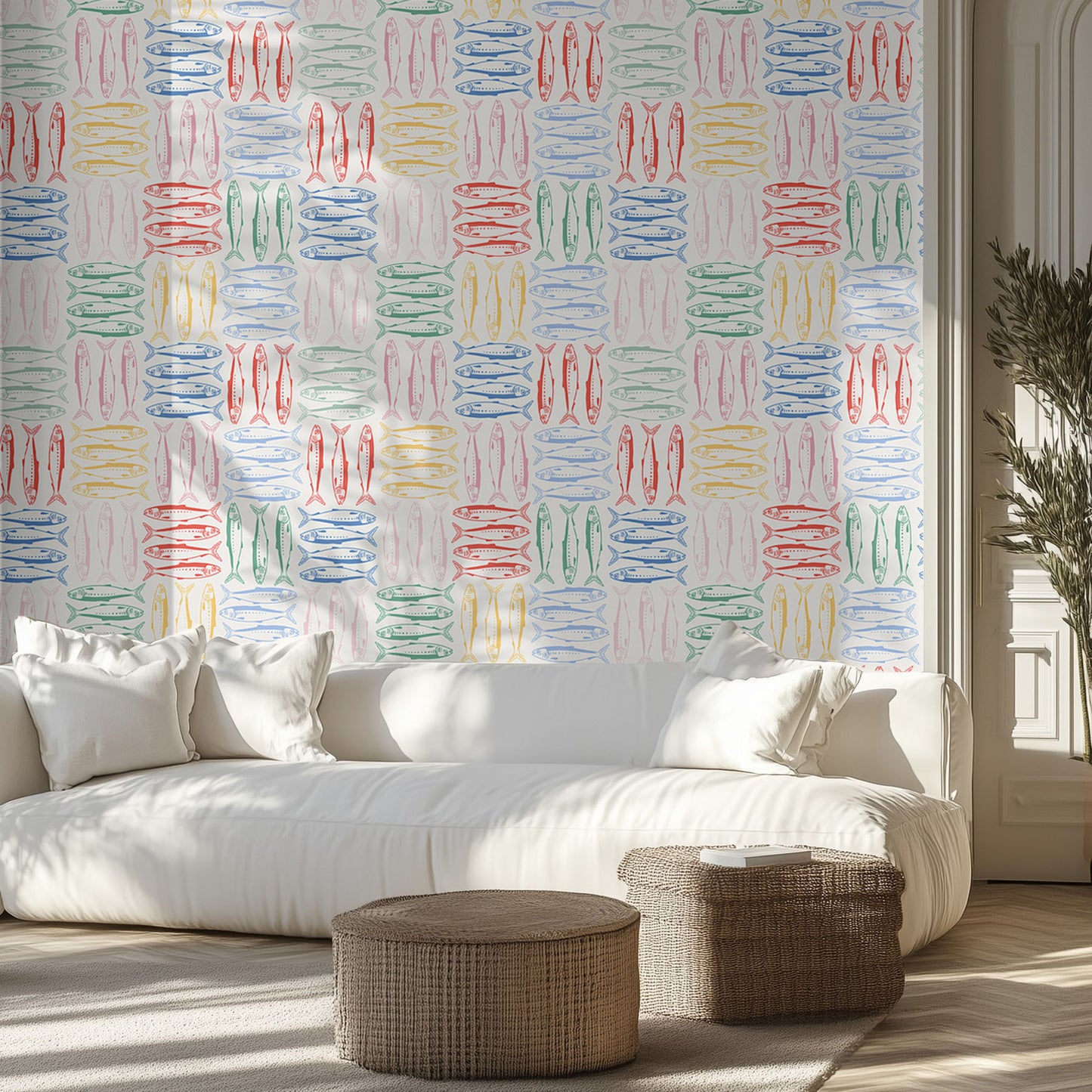Living room with a white sofa, colorful sardine wall pattern, and wicker ottomans.
