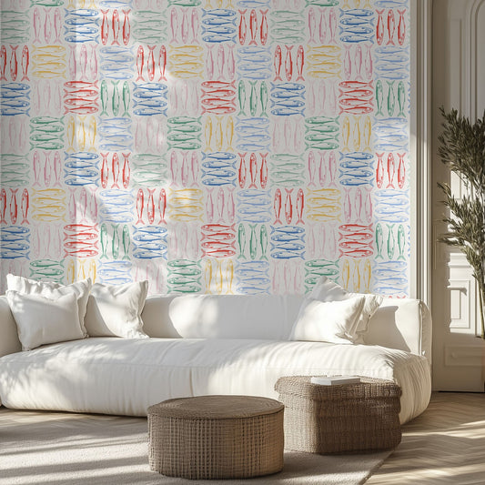 Living room with a white sofa, colorful sardine wall pattern, and wicker ottomans.