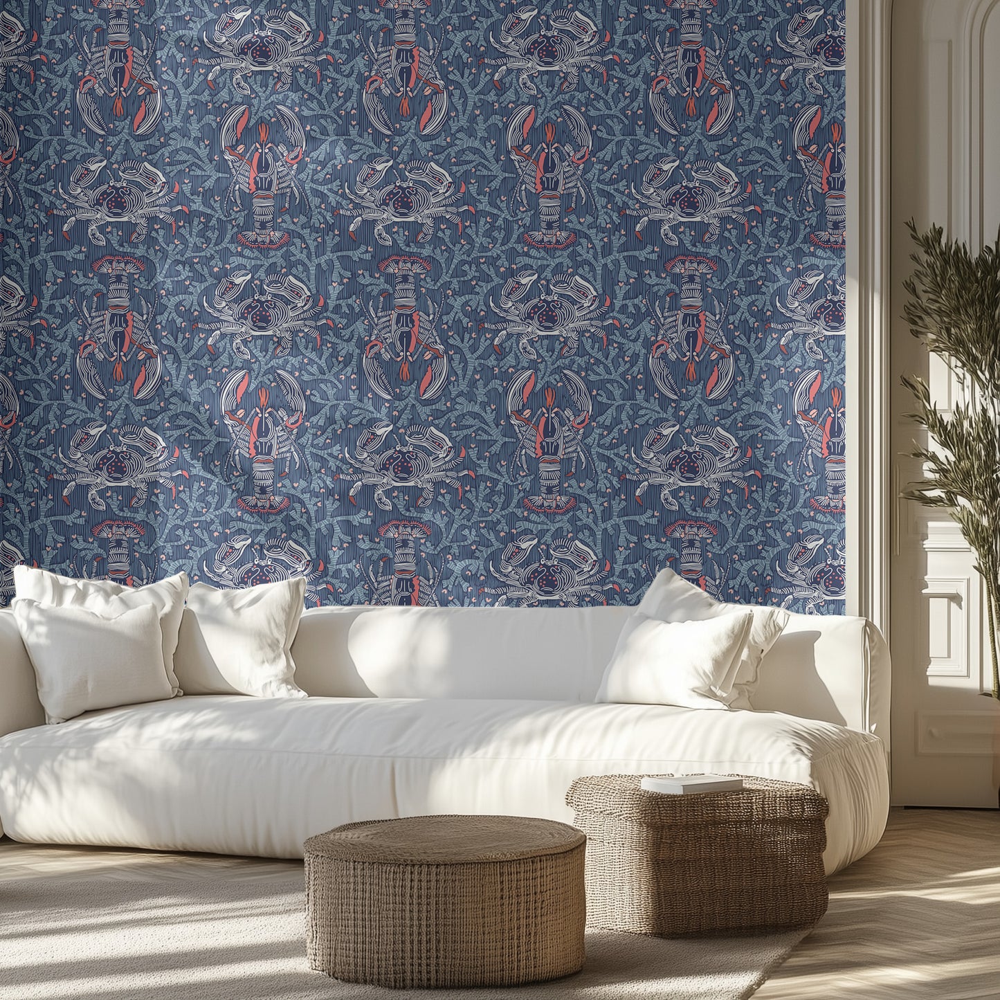 Living room with white sofa, navy blue marine life patterned wall, and wicker ottomans.