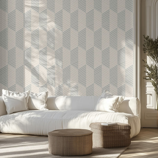 Modern living room with a white sofa, neutral, geometric patterned wall, and wicker ottomans.